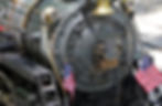 12-inch gauge steam locomotive #535 from up close with two American flags