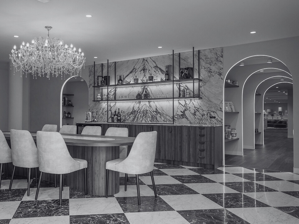 Wide shot of a creative workspace with shelves filled with books, small decorative items, and art supplies, creating a casual
