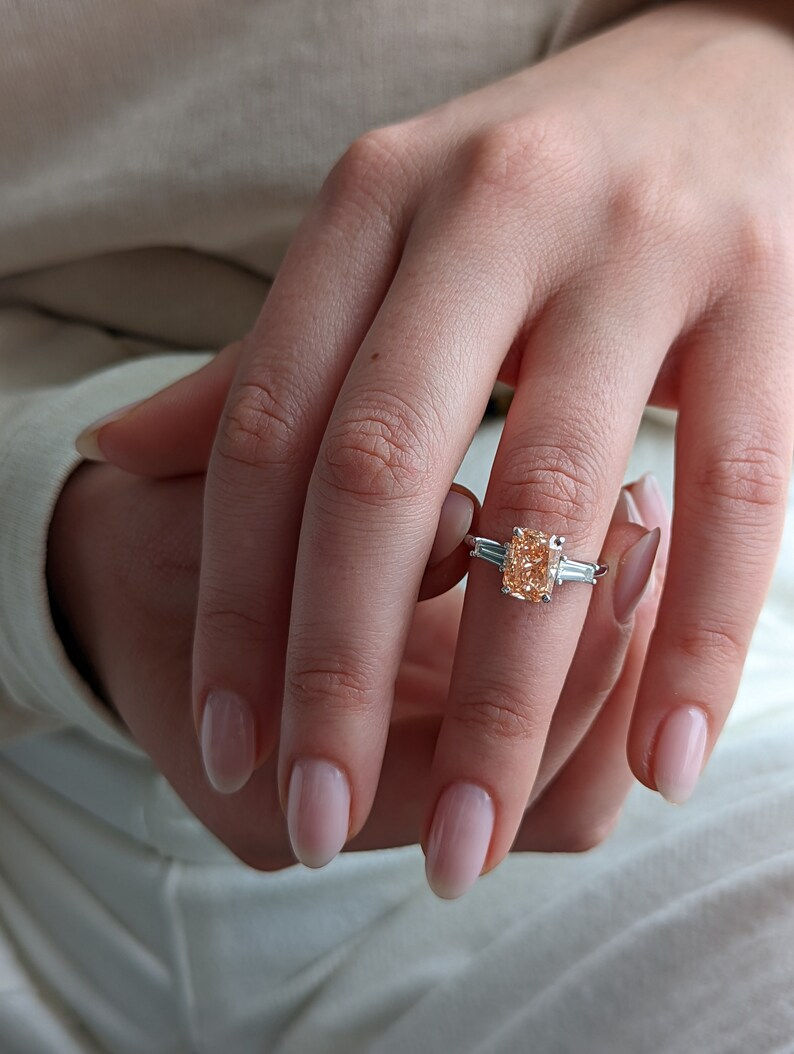 Pink radiant cut moissanite with side stones