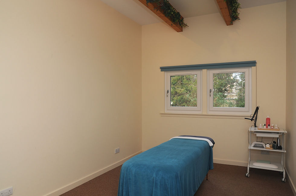 Eye-level view of a calm therapy room with massage table and soft lighting