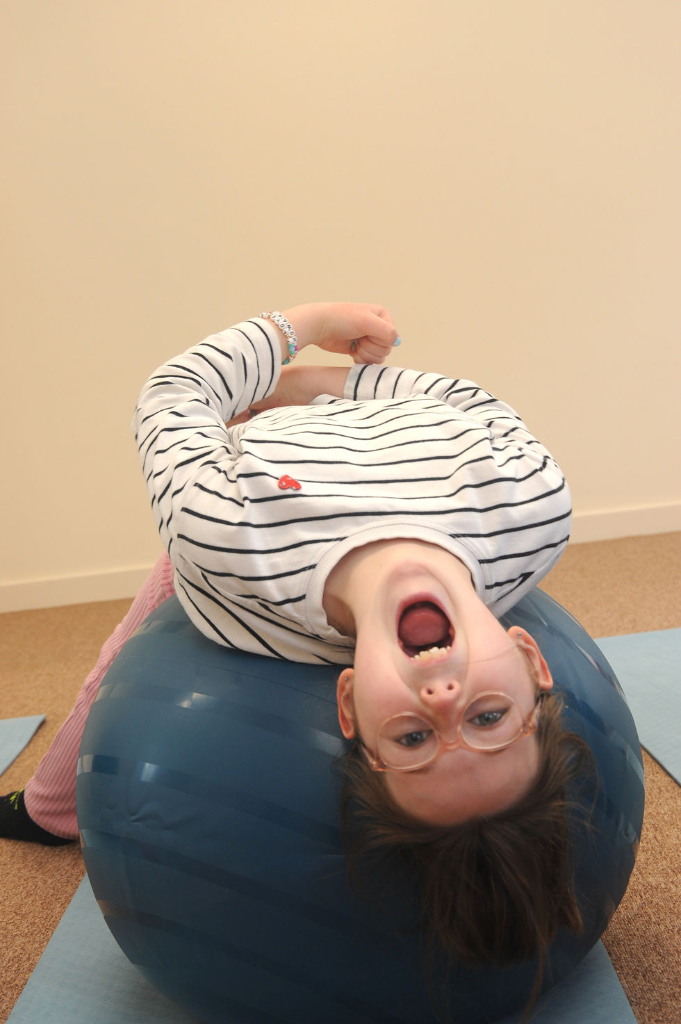 A child enjoying a fun fitness class at a family friendly fitness studio.