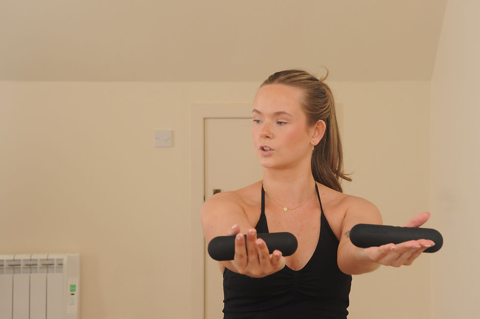 Close-up view of a yoga instructor demonstrating a pose in a bright studio