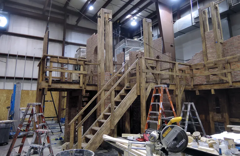A scenic platform and staircase finished at rough-hewn lumber for the Broadway set of Hamilton assembled at Hudson Scenic Studios' Yonkers, New York facilities.
