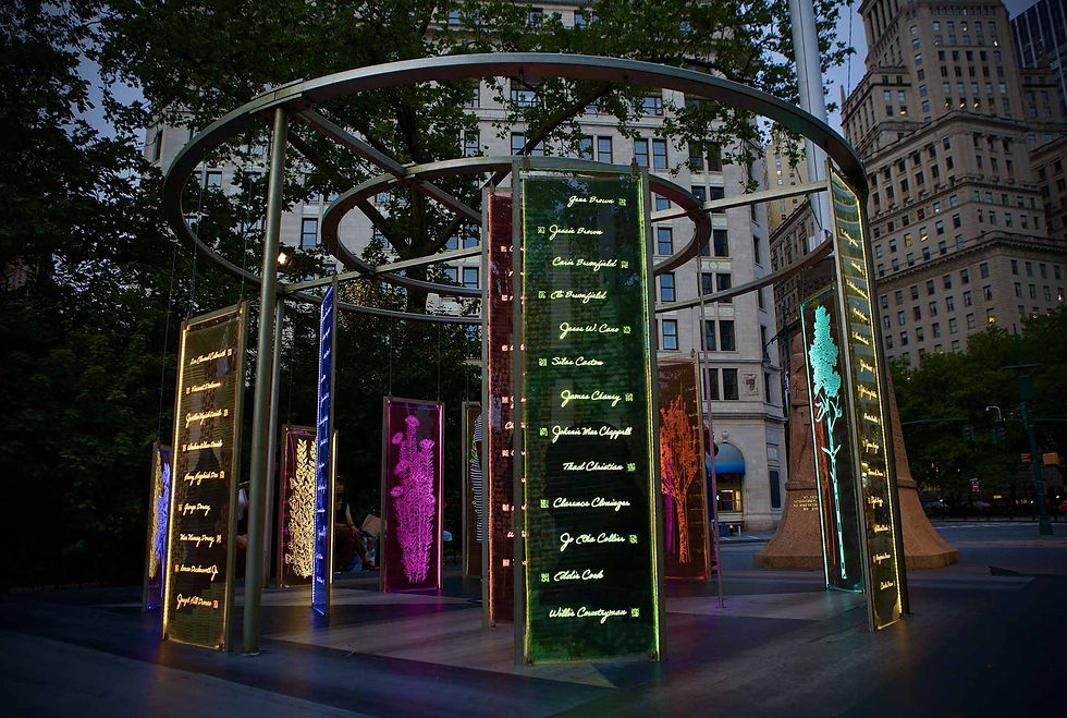 Un(re)solved, a pop-up modular AR art installation with an internal battery illuminates a list of names, QR codes, and outline illustrations at night.