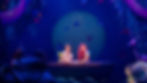 Disney cast members costumed as Ariel and Prince Eric sit in an automated scenic wagon finished as a wooden boat and surrounded by puppet hides while performing "Kiss the Girl" in Walt Disney World's live stage show, The Little Mermaid - A Musical Adventure.