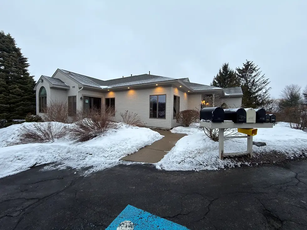 Exterior view of the office building at 5108 Velasko Road with mailboxes and snowy parking lot