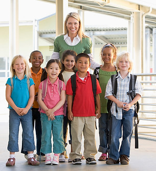 Teacher and Elementary Class with Backpacks On