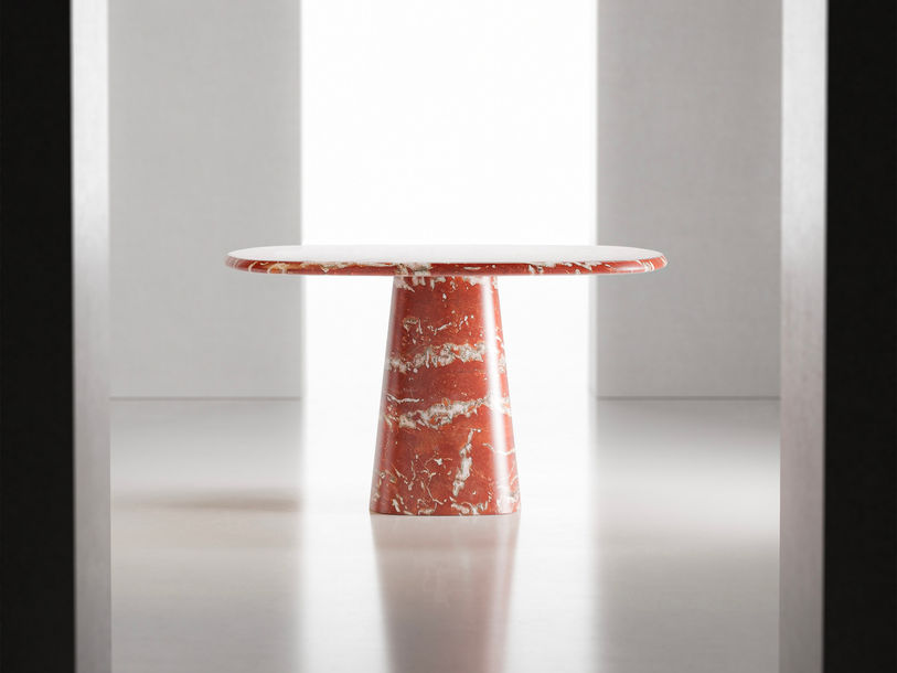 Wedge dining table made with Rosso Francia marble by serafini