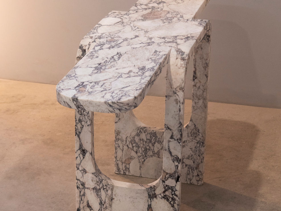 Cut and fold console made of Calaccatta macchia vecchia
