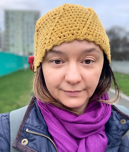 Woman in yellow hat and purple scarf