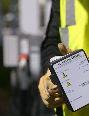 Technician holding EVSE tester (1).jpg