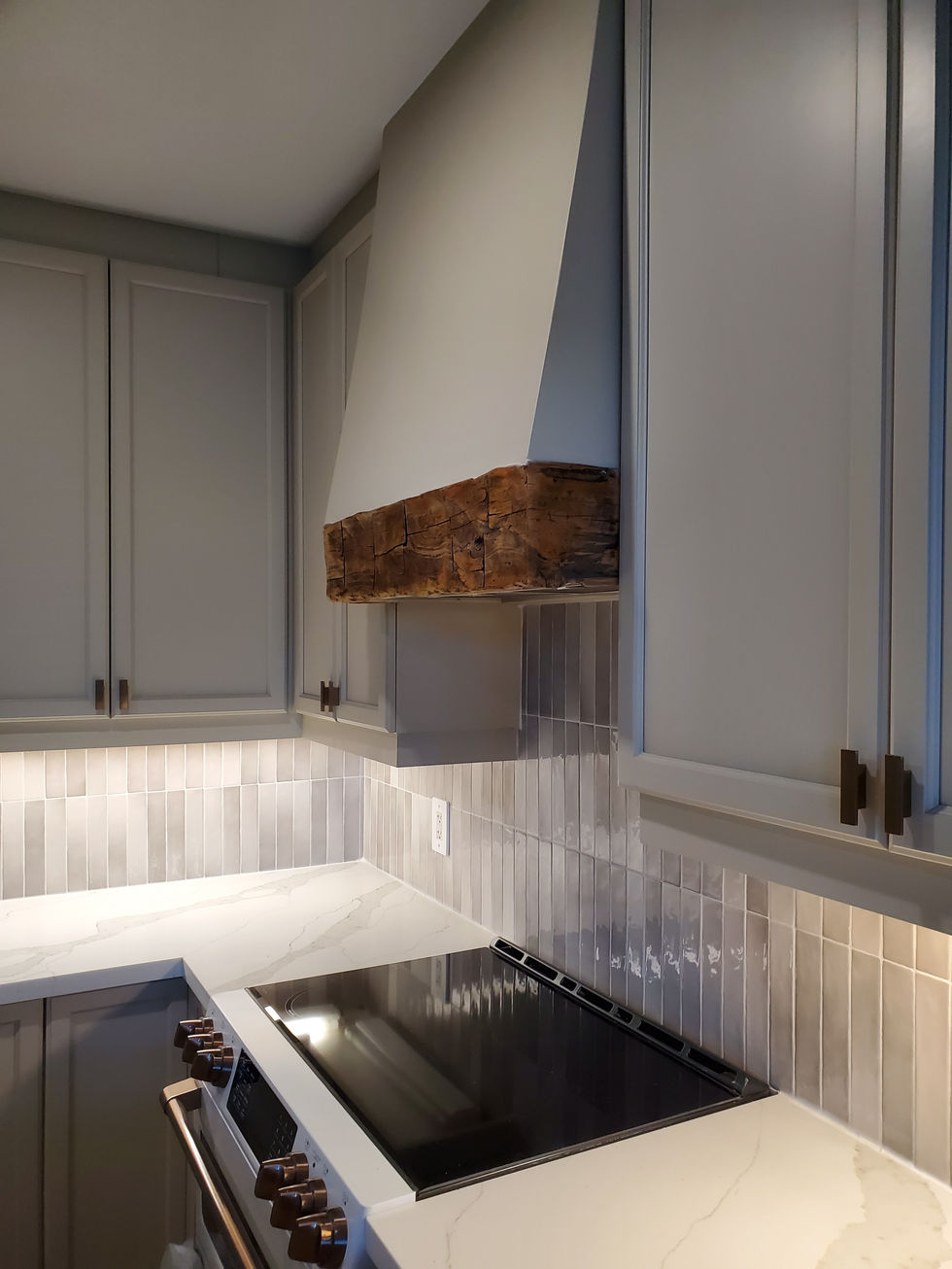 a kitchen with white cabinets and a stove top oven