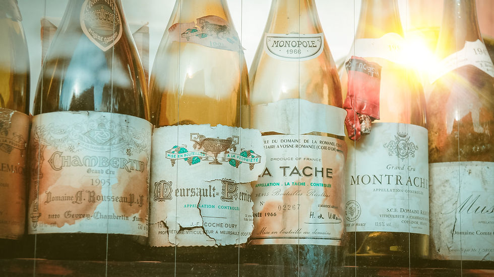 A prestigious collection of Burgundy wine bottles featuring distinguished labels such as Chambertin, Meursault-Perrières, La Tâche, and Montrachet, each representing the rich heritage and exquisite craftsmanship of the renowned wine region.