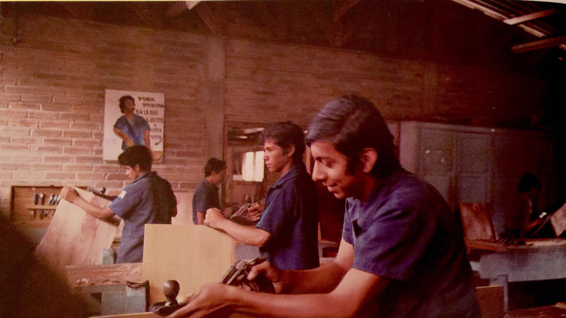 Young men working in the Valle de Ángeles Craft Training Center, learning carpentry. This place is connected to Marta Campos-Mace’s family history in Invisible Grounds.