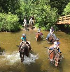 Ranch Rudolf horseback riding through river