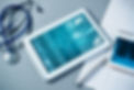 White tablet pc and doctor tools on gray