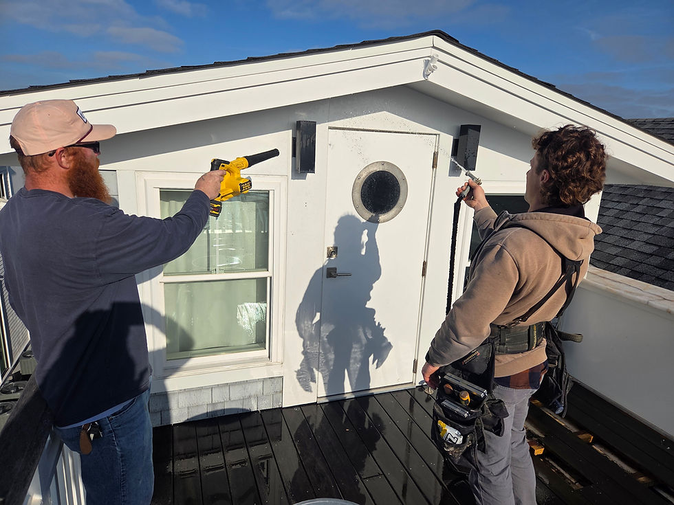 Technicians performing water intrusion diagnostics on a roof.