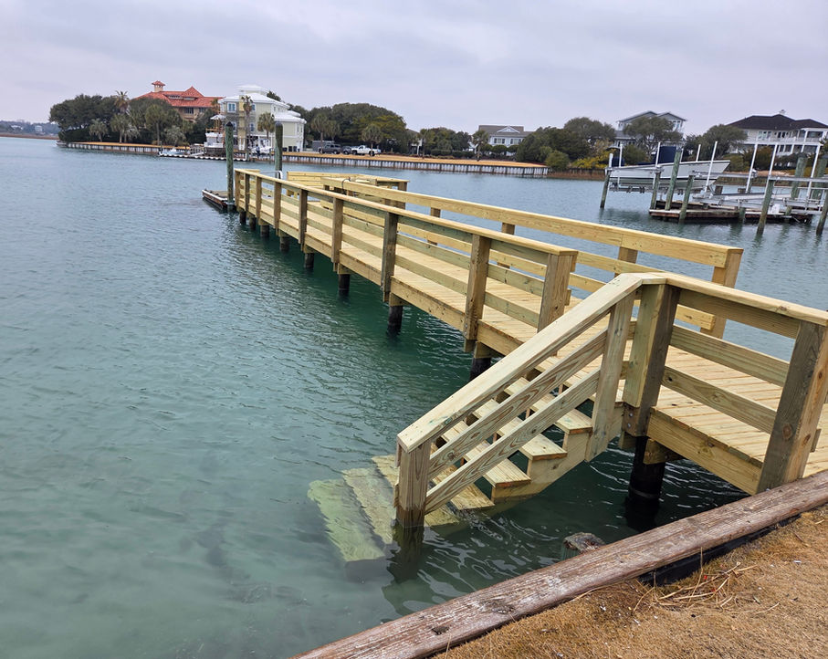 Wooden pier with stairs leading into the water.