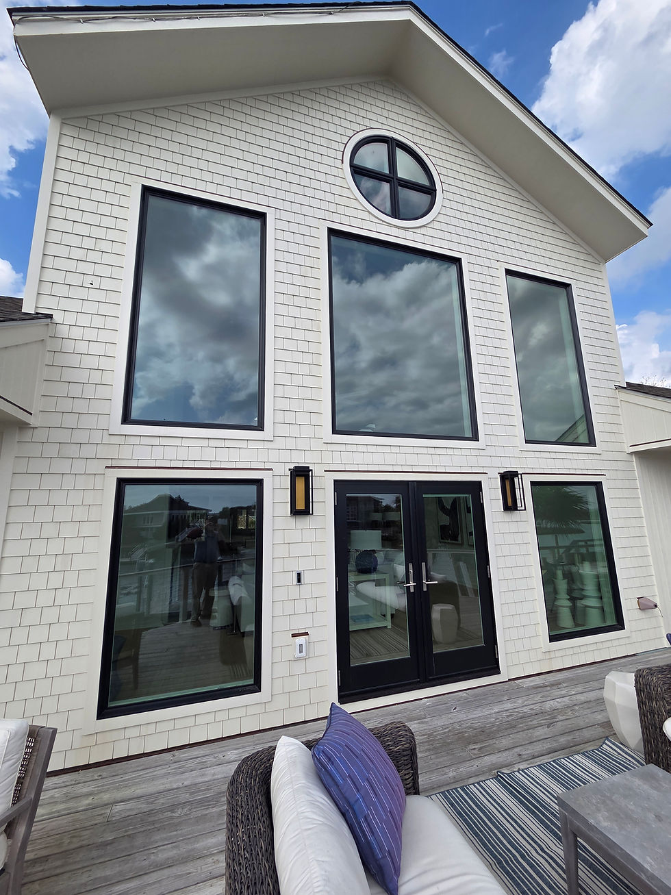 Modern home with black frame windows and French doors.