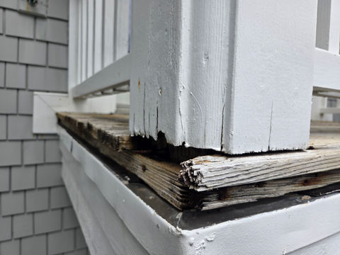 Close-up of water-damaged wood and rotting deck pilar base