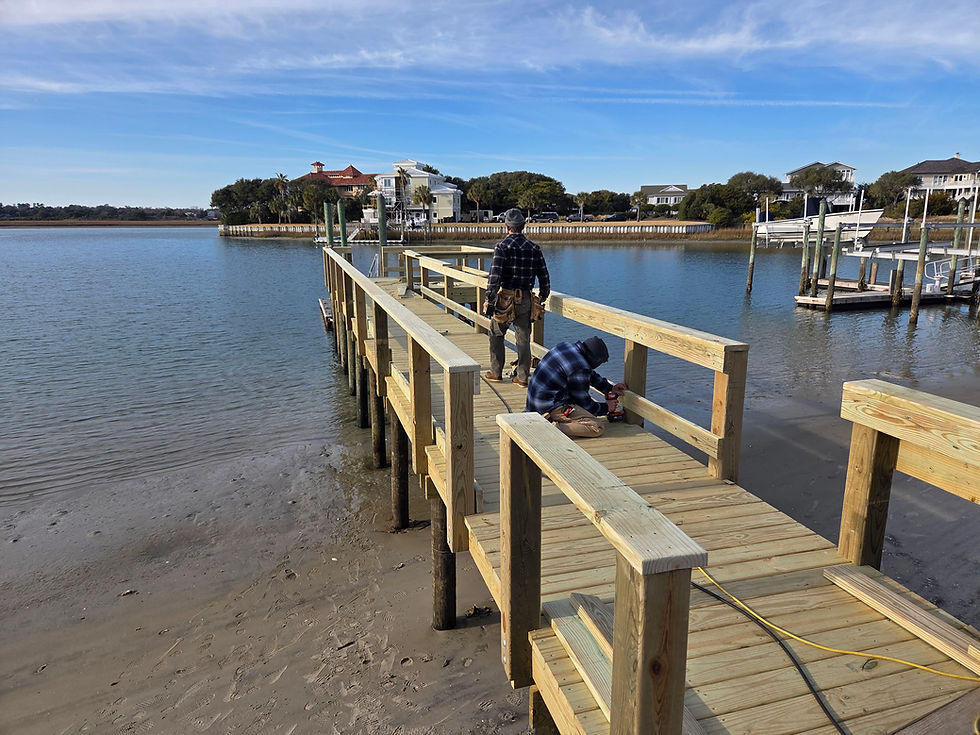 Workers performing dock repair and maintenance on a pier.