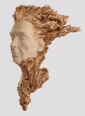 Side-profile view of Fire & Ice, a clay portrait sculpture featuring a serene, refined face surrounded by expressive, flame-like textures, photographed against a light-gray background.