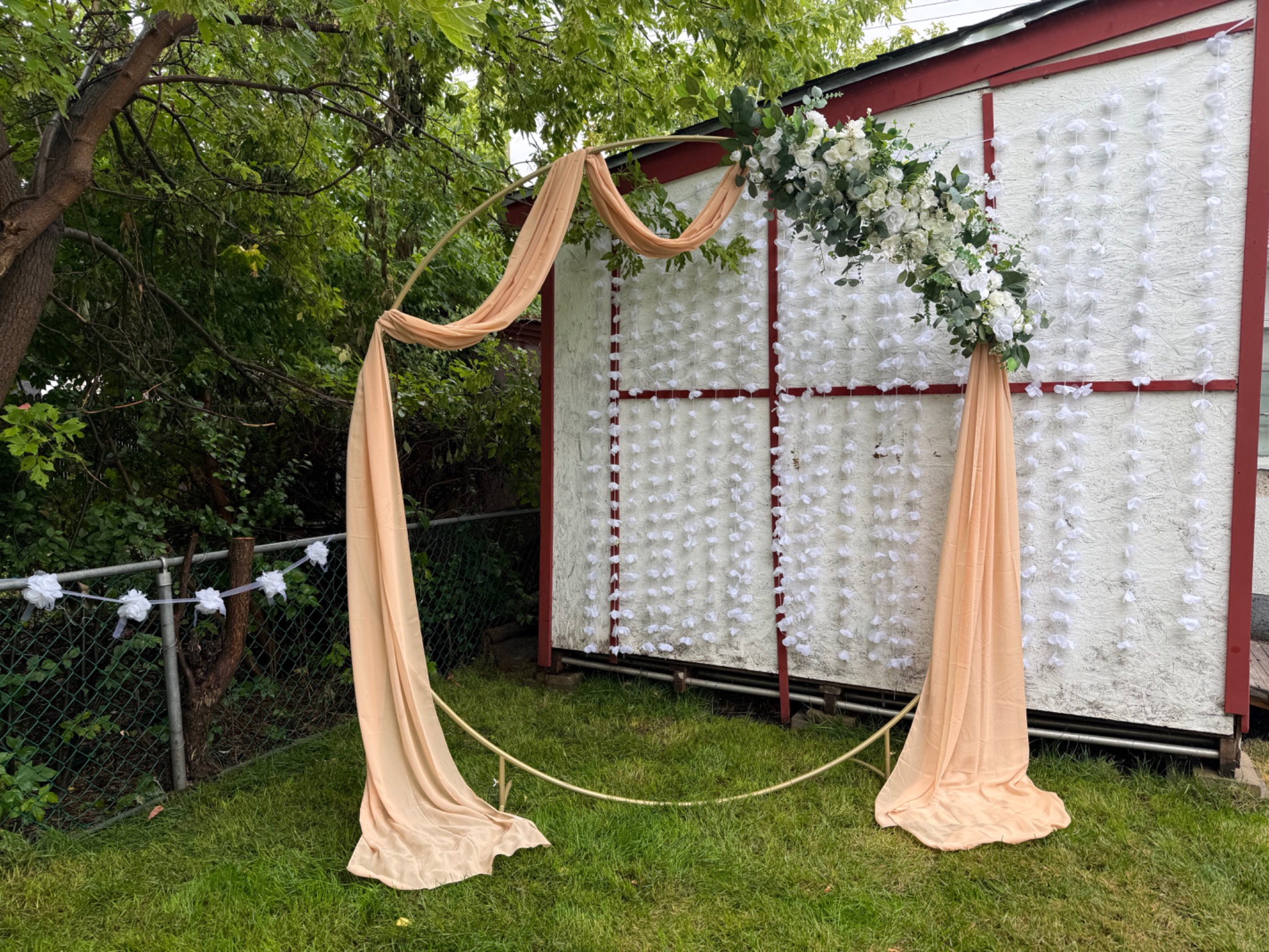 Outdoor champagne draping and floral arch