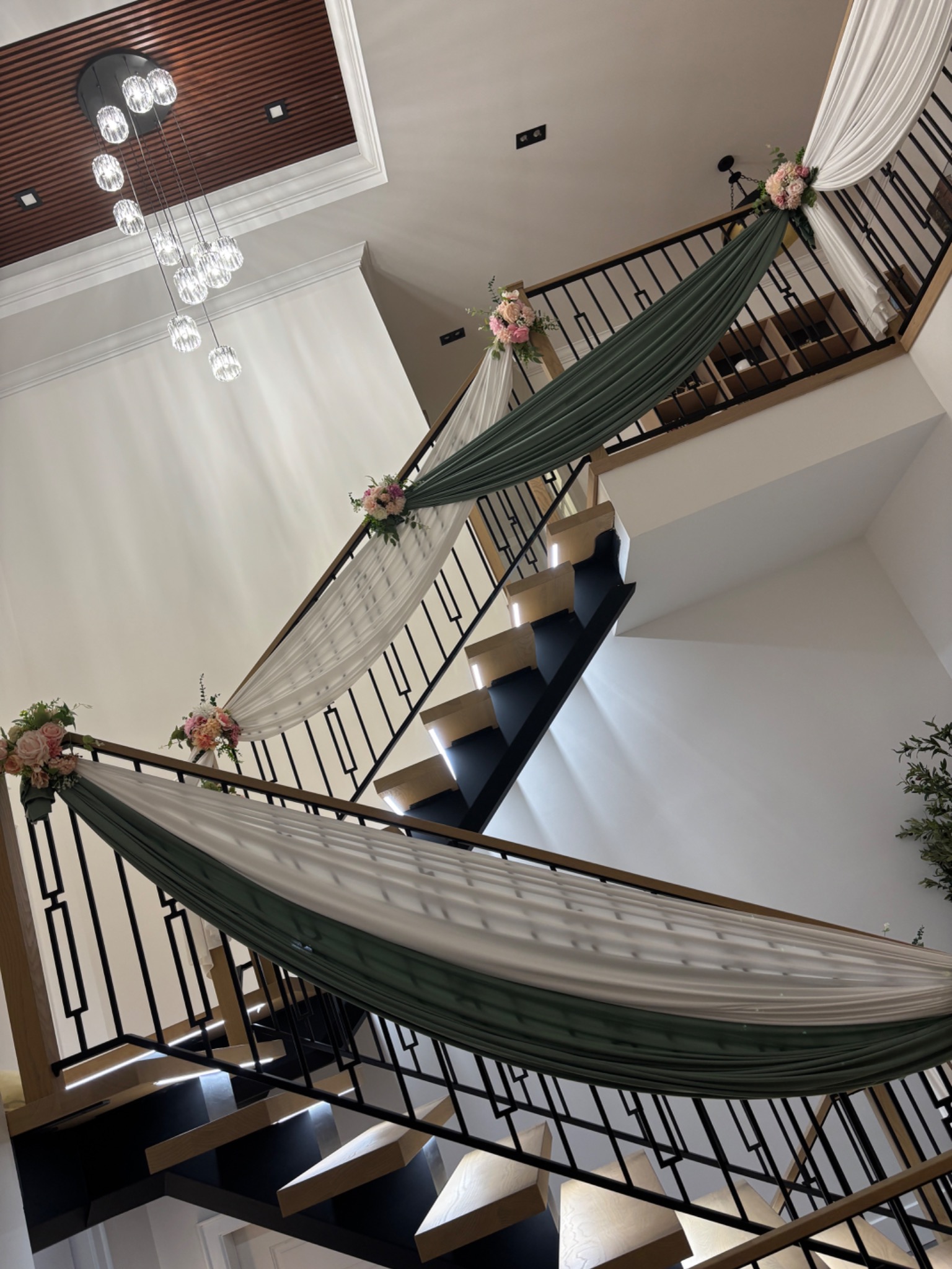 Sage and ivory stair draping with floral accents by Muse Events