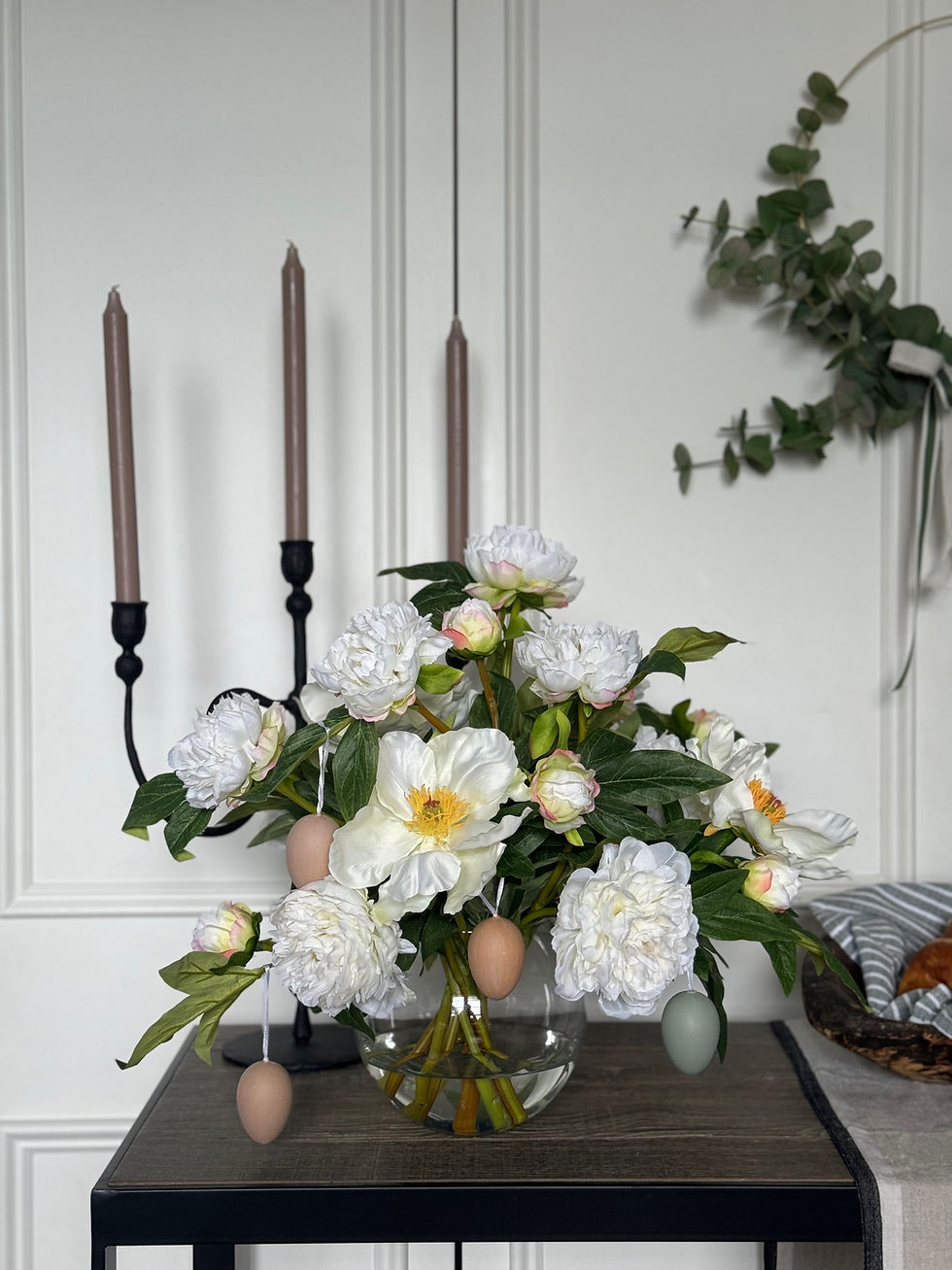 Faux peony arrangement dressed with easter eggs