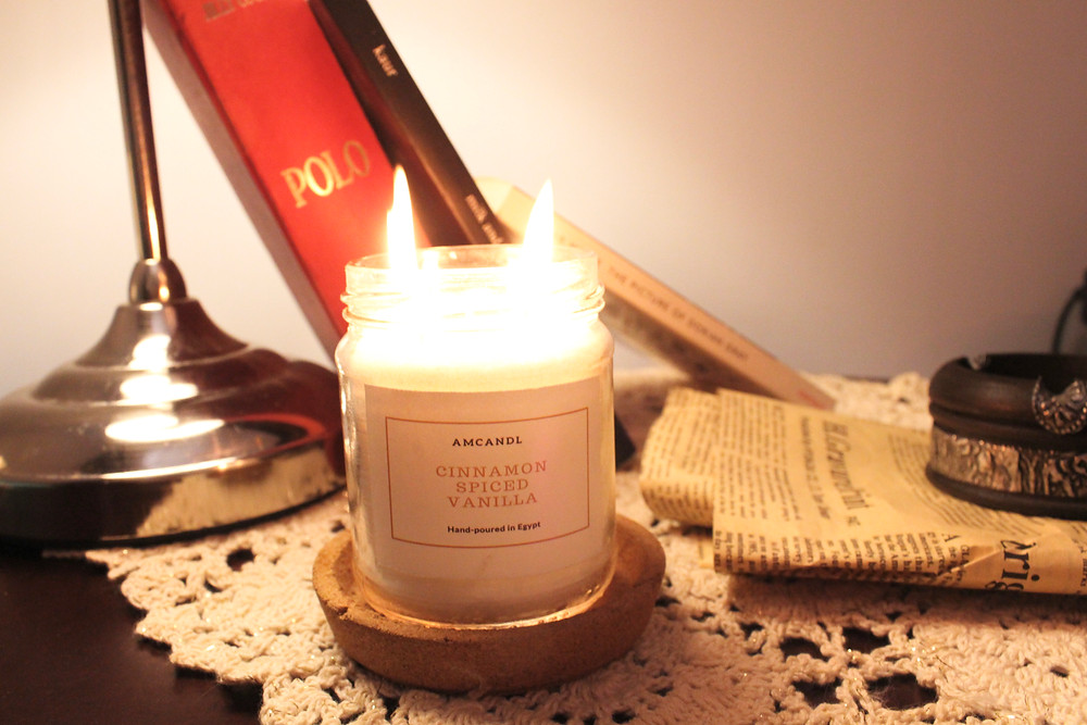 cinnamon vanilla candle with books