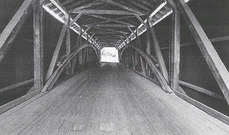 Example of a covered bridge from underneath looking at the structural part of the roof