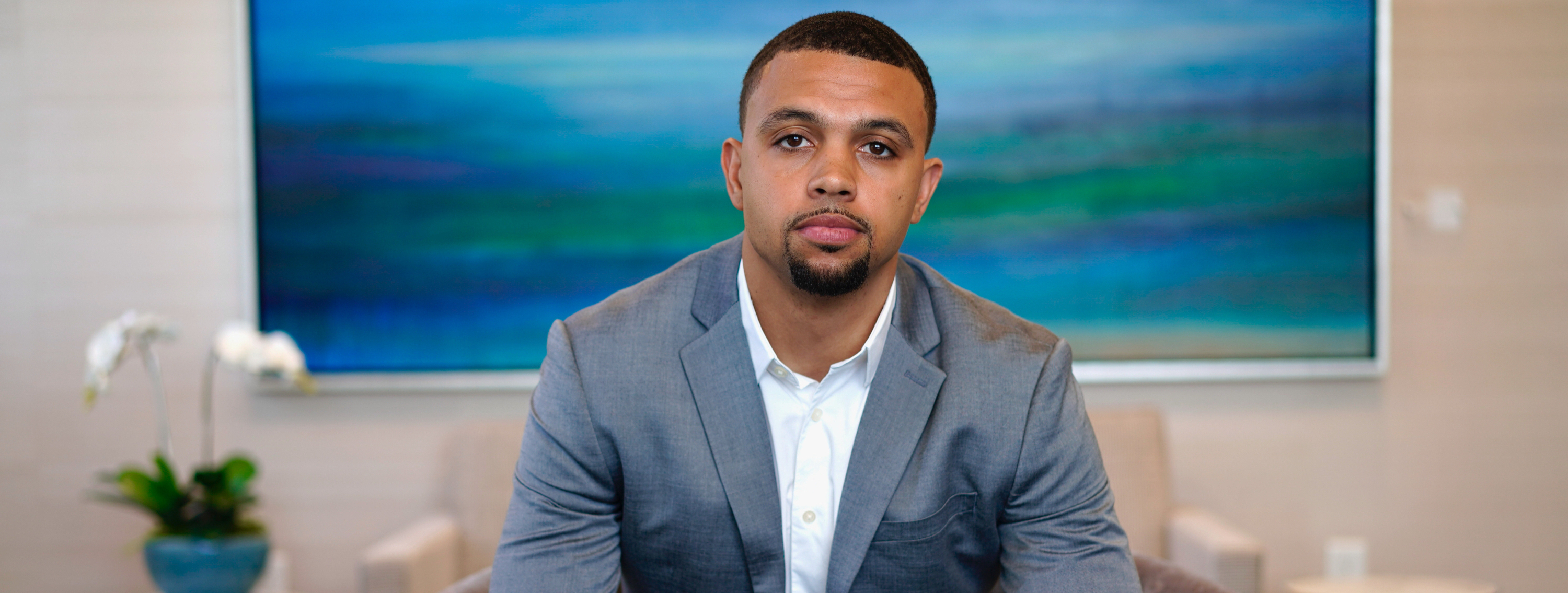 Tyler Patmon in a gray suit