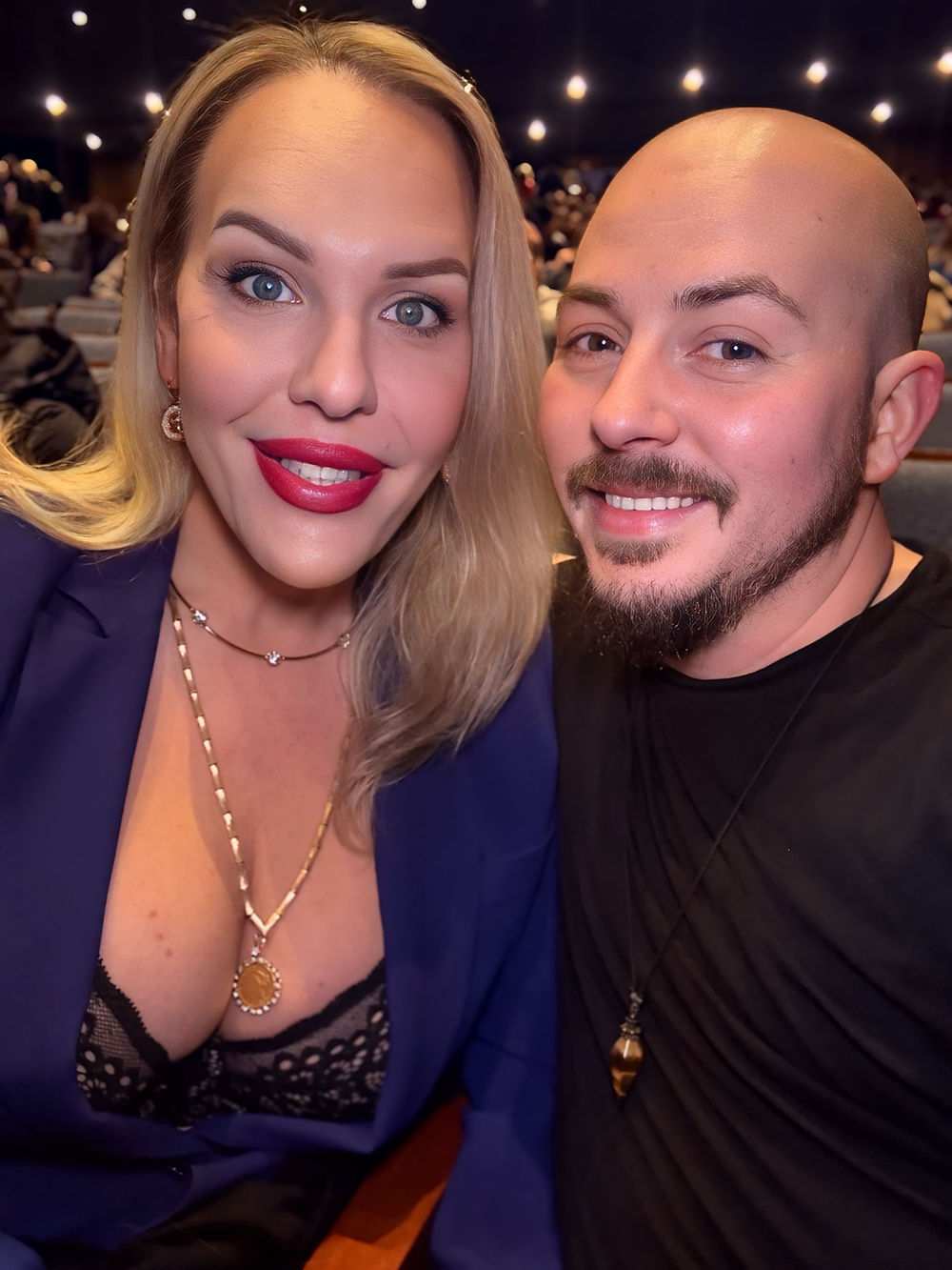 Blonde woman and bald man smiling together