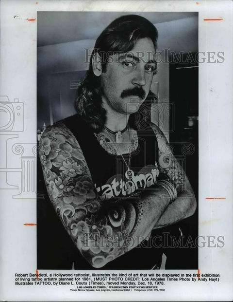 Robert Venables, a Hollywood tattoo artist, heavily tattooed arms crossed