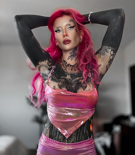 alternative heavily tattooed model with pink hair and tattoos