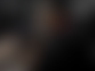 a Black woman tattoo artist working on a client