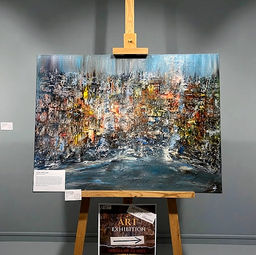 Exhibition view of the textured abstract painting by Arlia-Hamda Elmi, Atlantis Harmony on a wooden easel against a neutral gallery wall.
