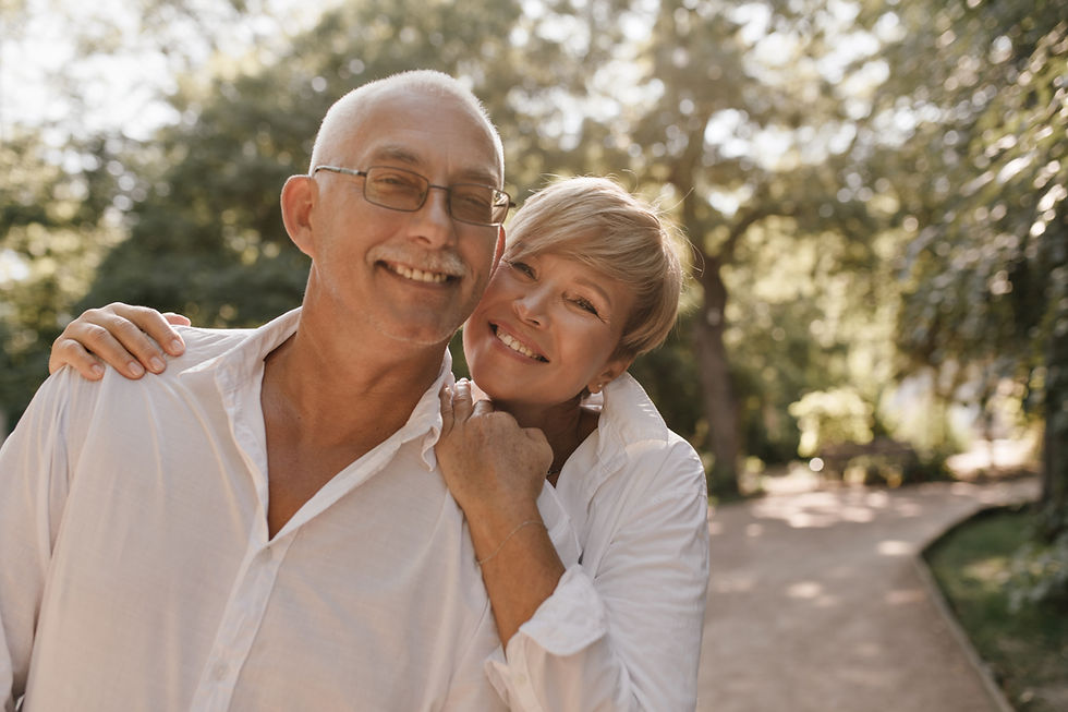 smiling-old-man-with-grey-hair-and-mustache-in-glasses-and-light-shirt-hugging-with-blonde