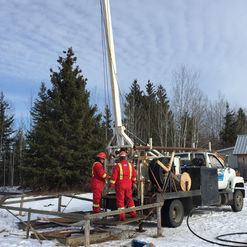 Two workers preparing for well testing