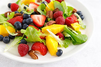 Fruit and berry salad with strawberry, blueberry, raspberry, mango and pecan nuts.