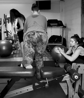 Corrective Exercise Specialist motivating clients in partner personal training session at Gray Training Personal Training Studio