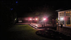 Premium outdoor uPVC deck installation illuminated by integrated exterior spotlights at night in Abe