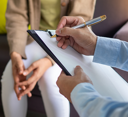 Therapist taking notes during a client session, symbolizing the collaborative and tailored approach of Mind Flow Hypnotherapy