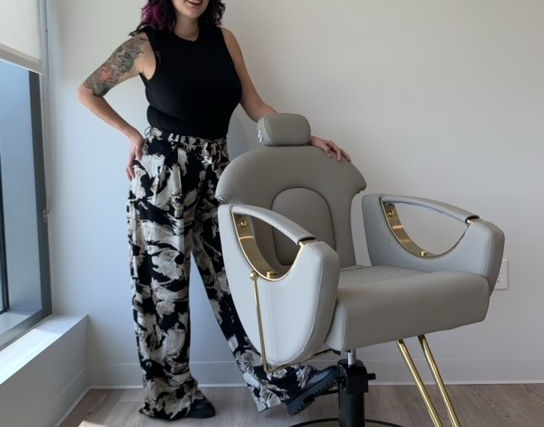 owner standing behind chair