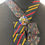 Thumbnail: tie necklace in red and gold with multi coloured millefiori broach stocking filler