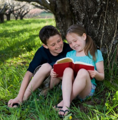 Children reading under a tree