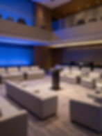 Corporate event lounge with modern seating and blue wall light