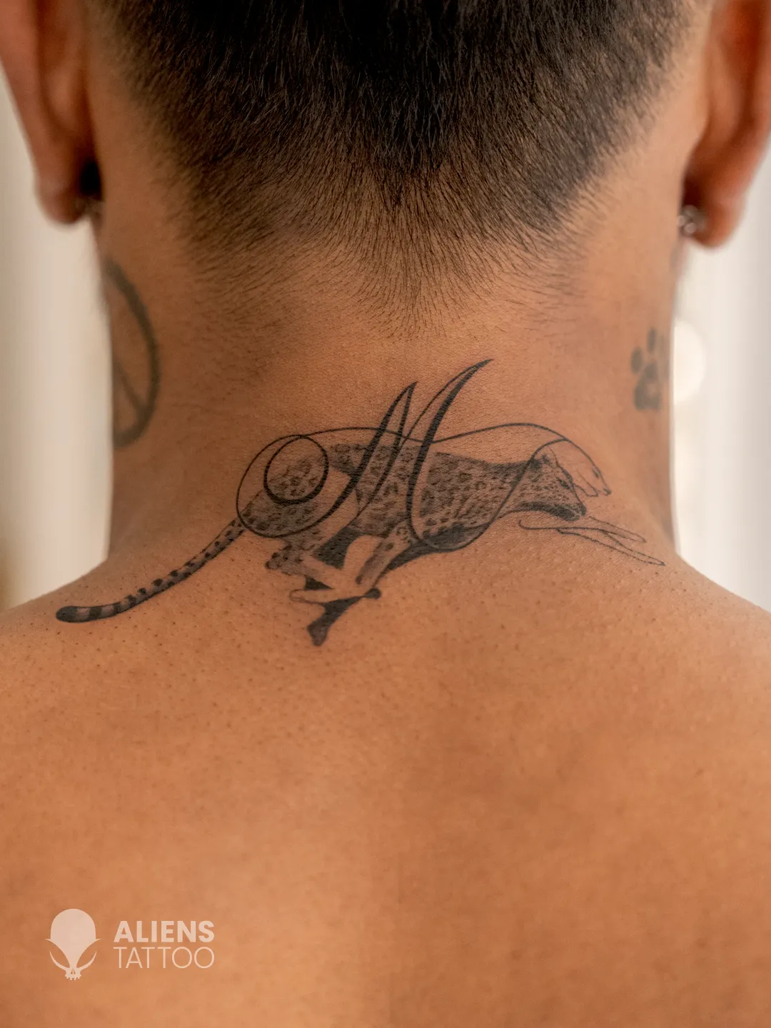 Close-up of tattoo artist Tushar Marane inking the realistic leopard design on Hardik Pandya.