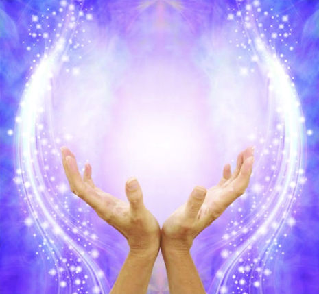 Beautiful healing energy shining from Reiki hands  