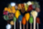 Many multi colored spices and dried fruits on the table. Background concept with spices..j